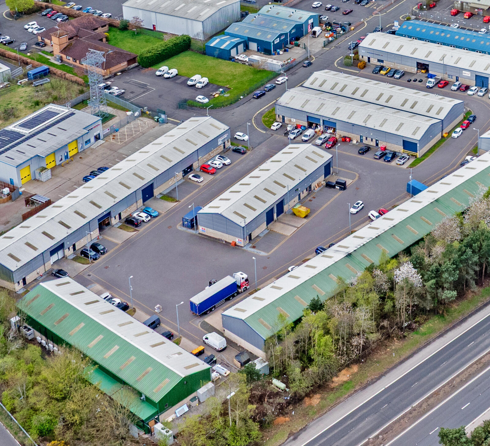 Aerial view of E-Net Park at Mill Road Industrial Estate in Linlithgow, showing modern business units and storage facilities